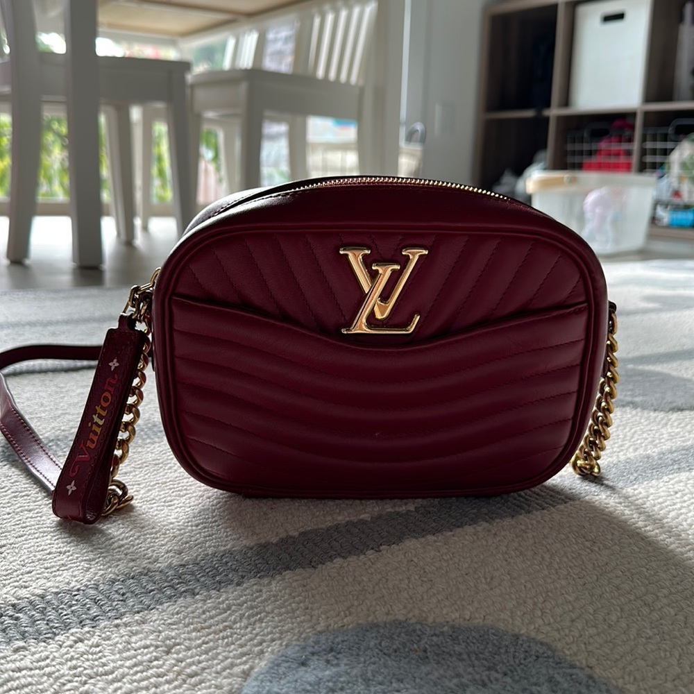This is an authentic LOUIS VUITTON Calfskin New Wave Camera Bag in red